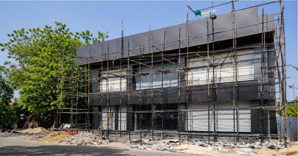 Professional building construction work with scaffolding at an active construction site in Agra, Uttar Pradesh
